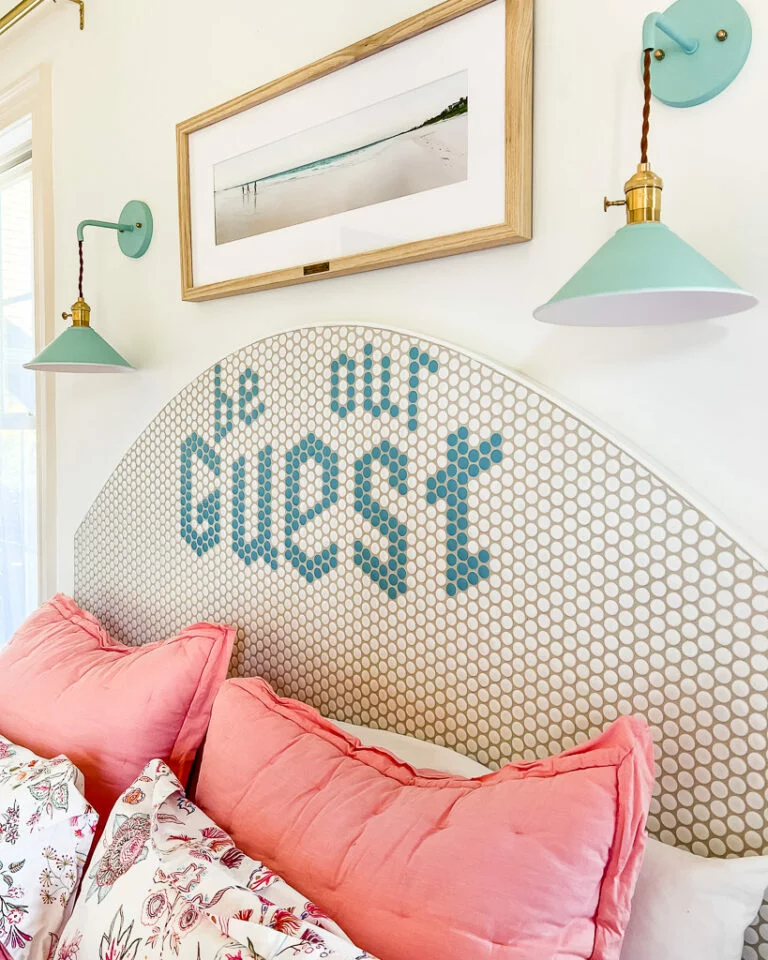 diy headboard with message that says "be our guest"