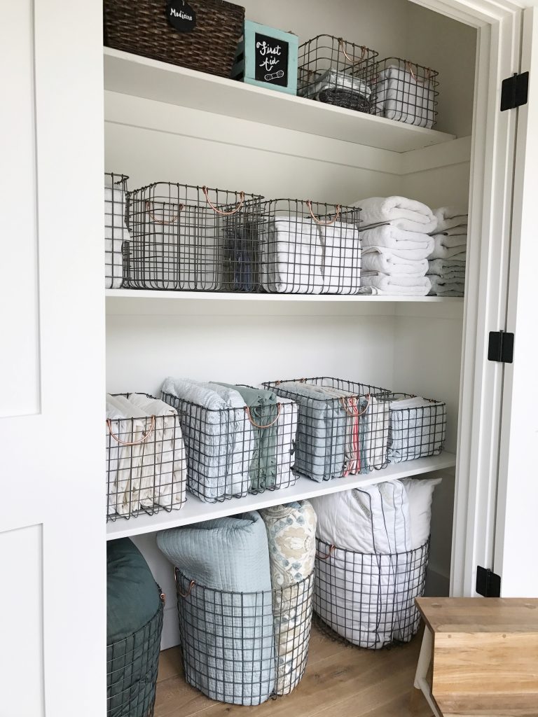 linen closet with wire basket storage