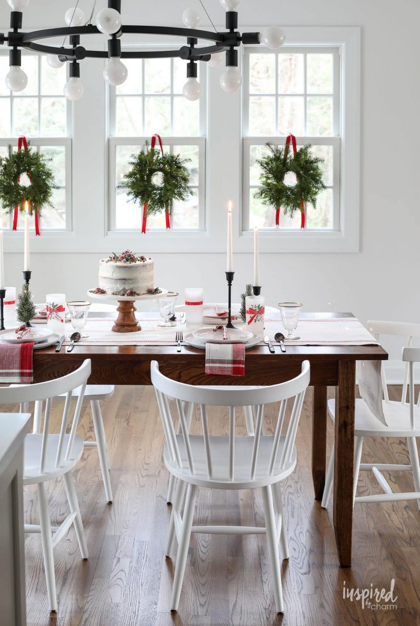 dining room decorated for Christmas with wreaths in windows