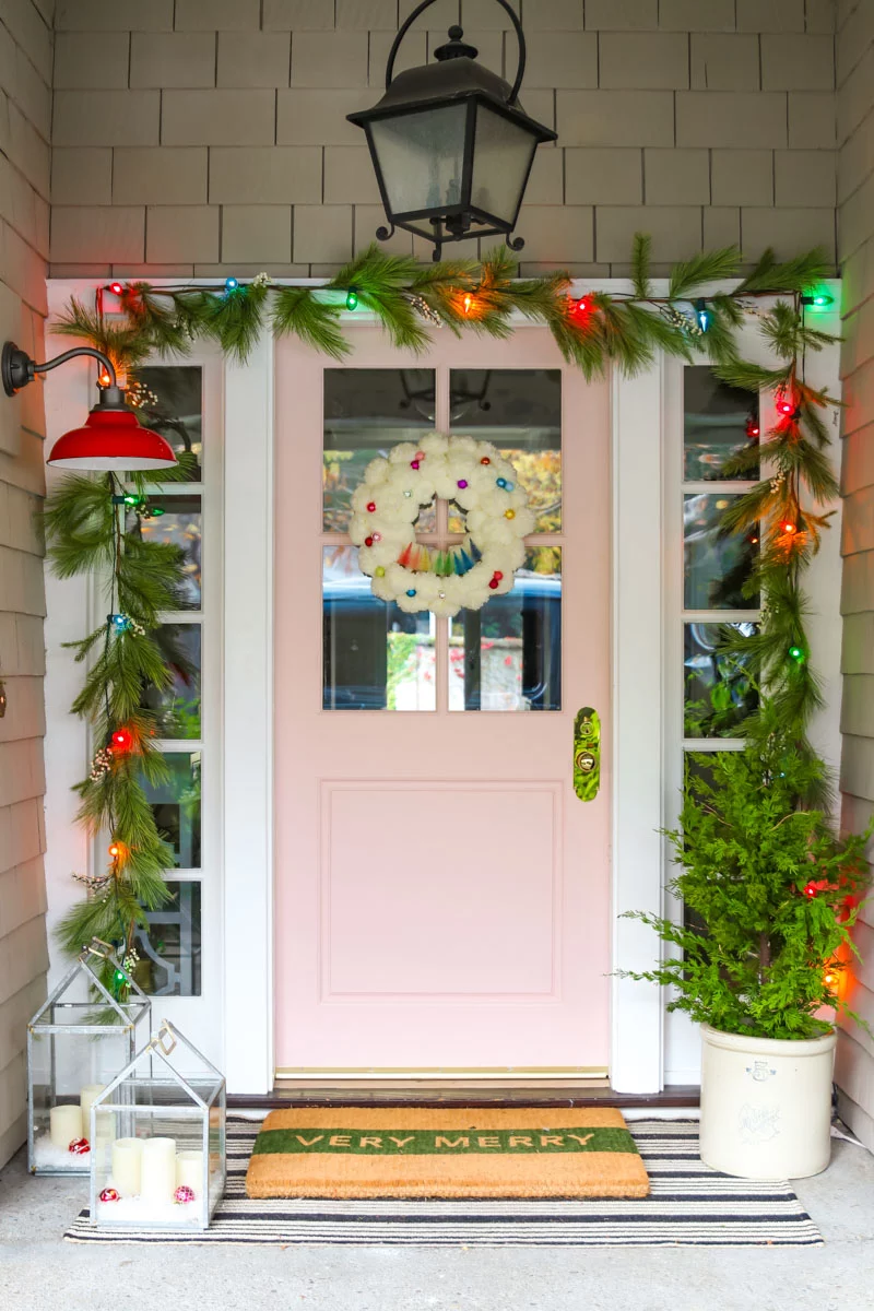 Christmas Front Porch with Fresh Greens and Pink Front Door - Nesting With  Grace