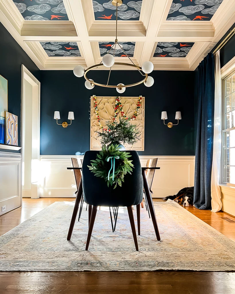 navy blue dining room decorated for Christmas with paper lanterns by Tasha Agruso of Kaleidoscope Living