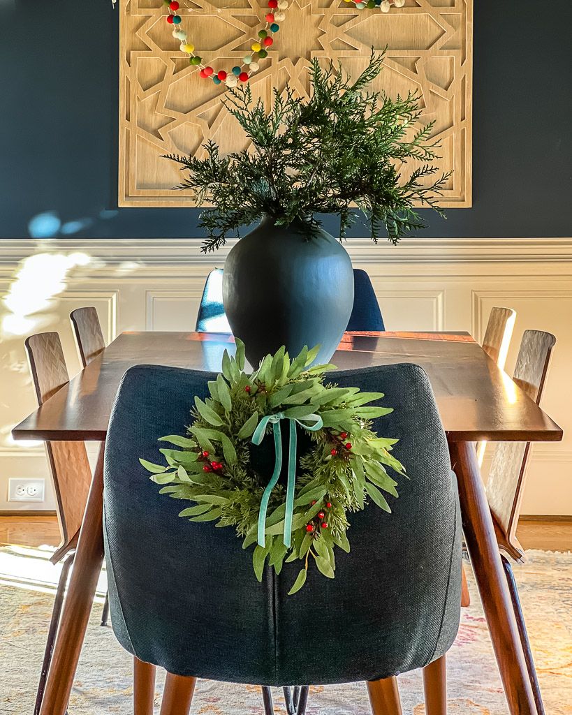 mini wreaths on dining room chairs for Christmas by Tasha Agruso of Kaleidoscope Living