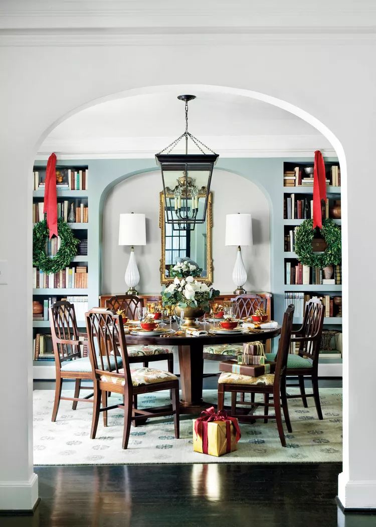 dining room with Christmas wreaths hanging built-in bookcases