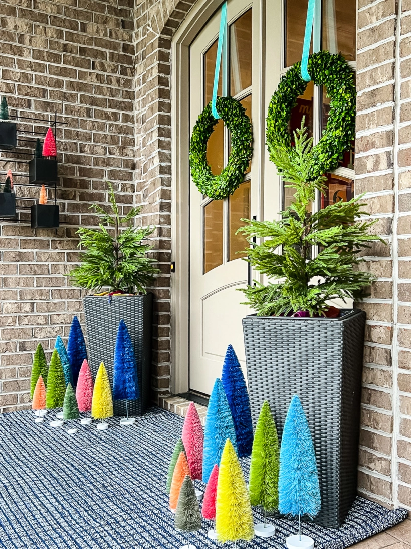 colorful front porch Christmas decorations and Annie Sielke rug by Tasha Agruso of Kaleidoscope Living