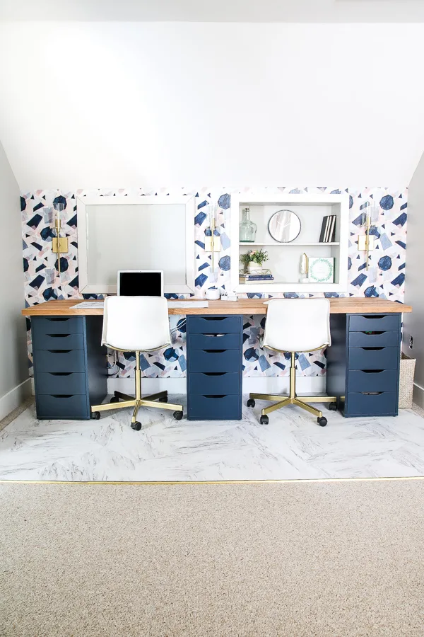 IKEA desk with navy drawers and wallpaper behind it