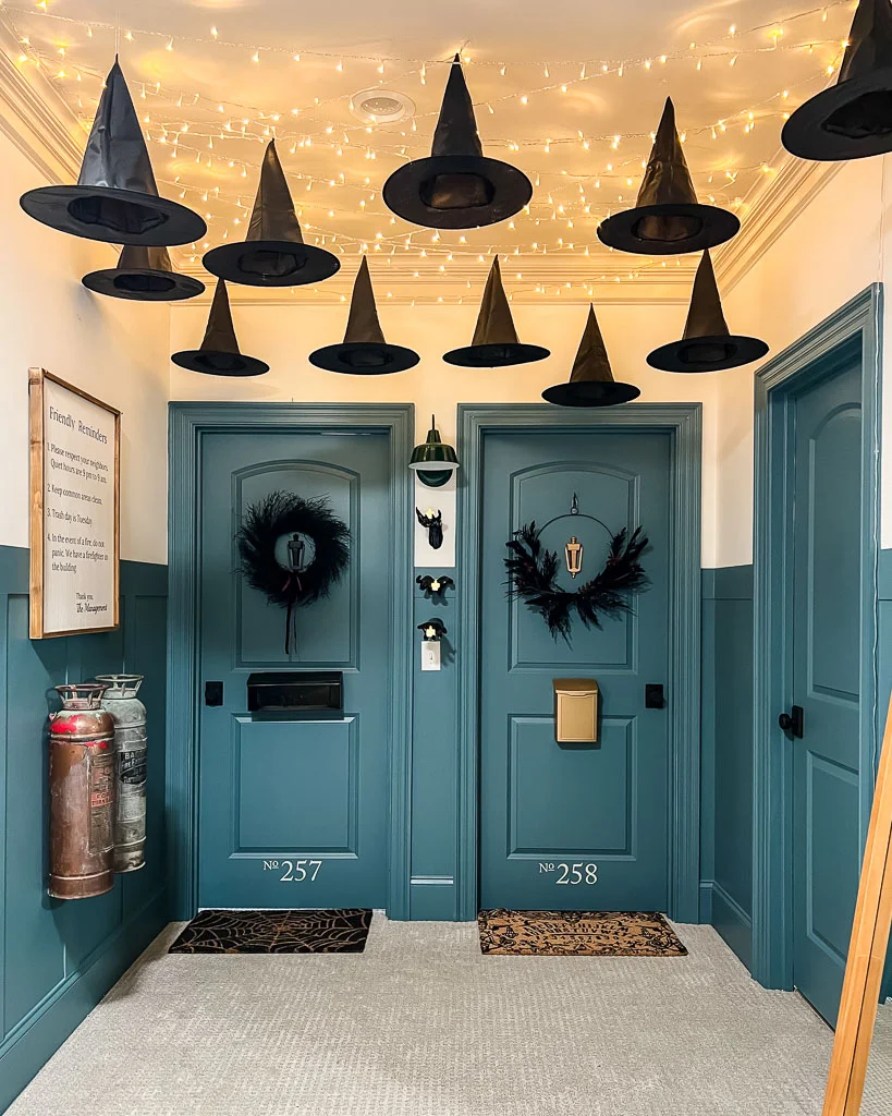 kids' bedroom doors decorated to look like apartment doors with Halloween decor