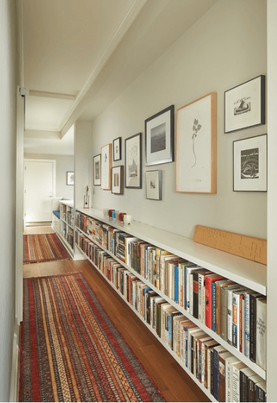 hallway with bookshelves and gallery wall