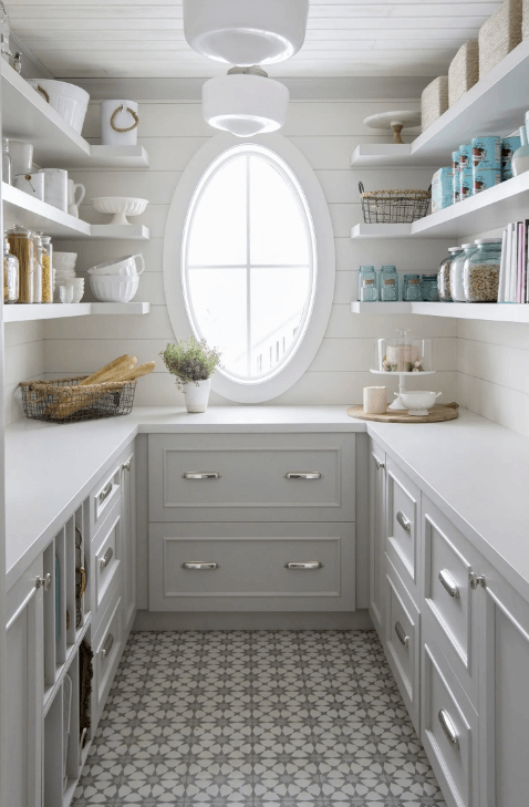 white pantry with cabinets and open shelving and oval window