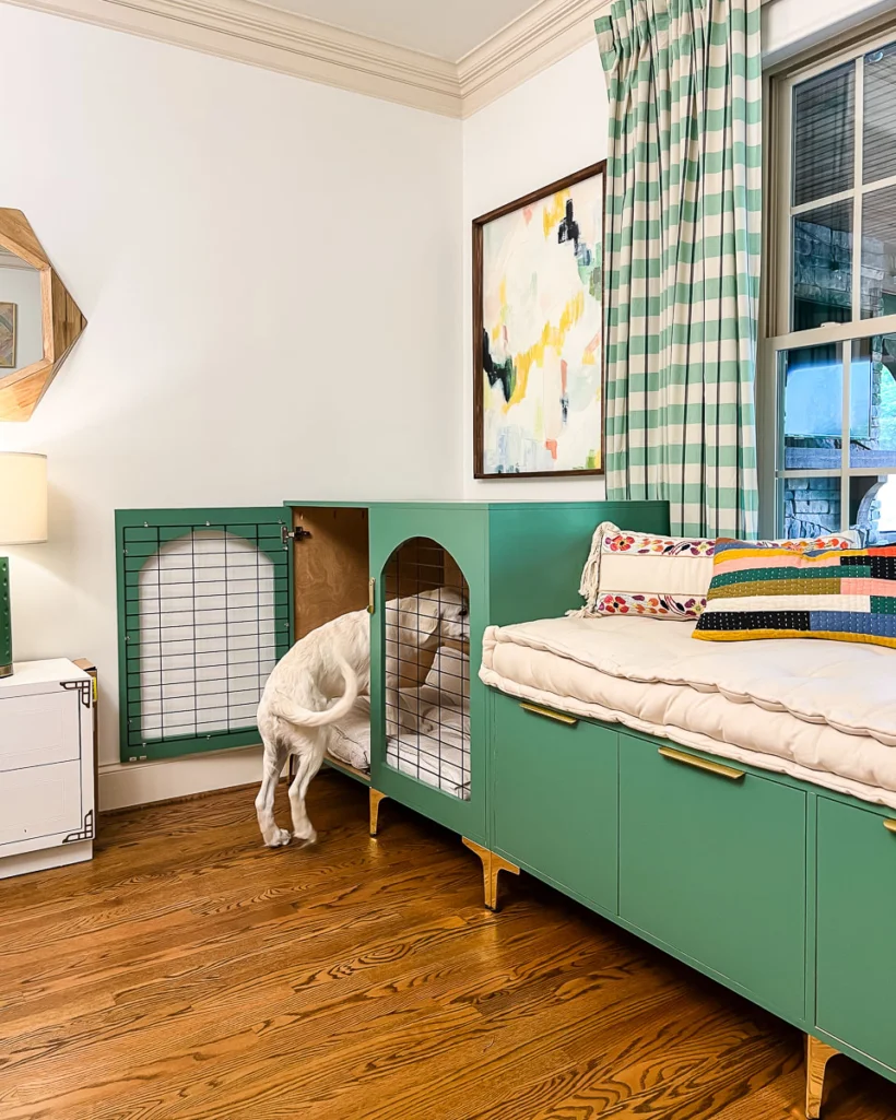 photo of DIY dog crate that looks like furniture and bench painted a green color