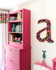 girls bedroom with pink painted IKEA Billy bookcase on top of dresser