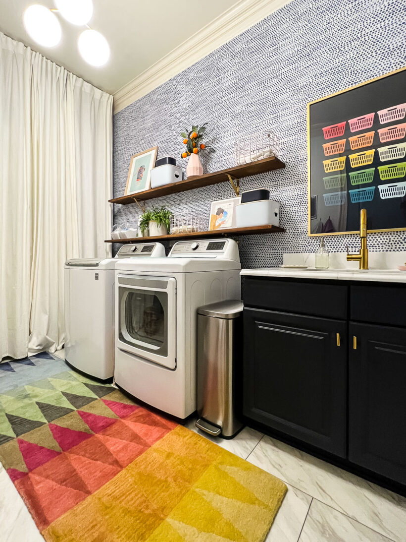 A brightly colored geometric affordable area rug in a laundry room. 