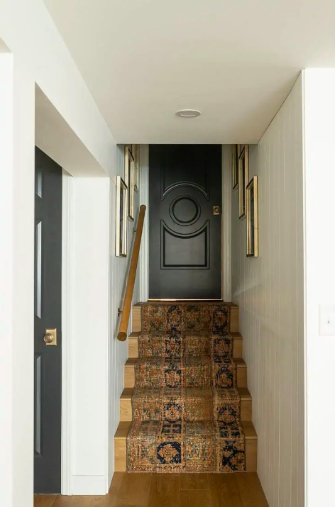 basement stair makeover with runner and dark doors 