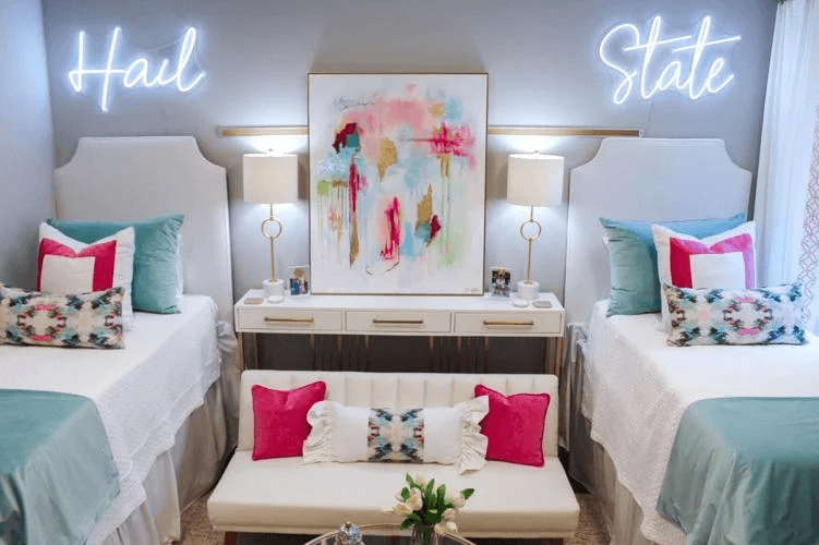 bright glam dorm room decor with neon sign and futon