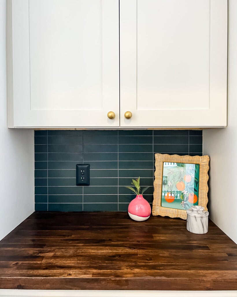 modern stacked kitchen backsplash with navy blue tiles white cabinets and wood countertops