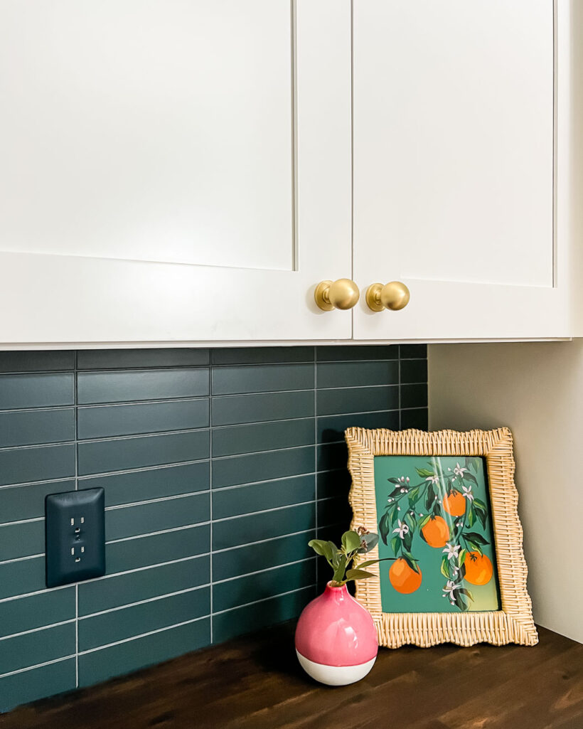 modern stacked kitchen backsplash with navy blue tiles white cabinets and wood countertops