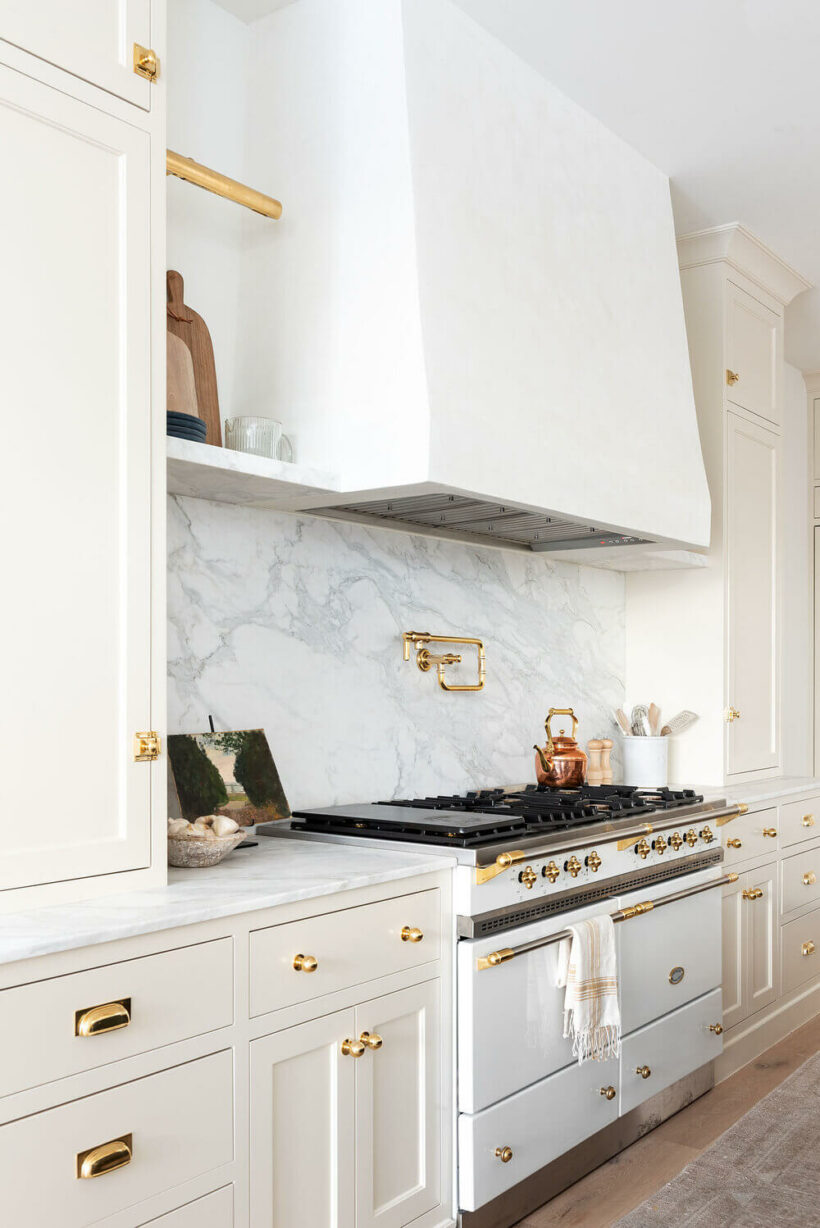 Creamy White by Benjamin Moore on cabinets with white vent and marble backsplash