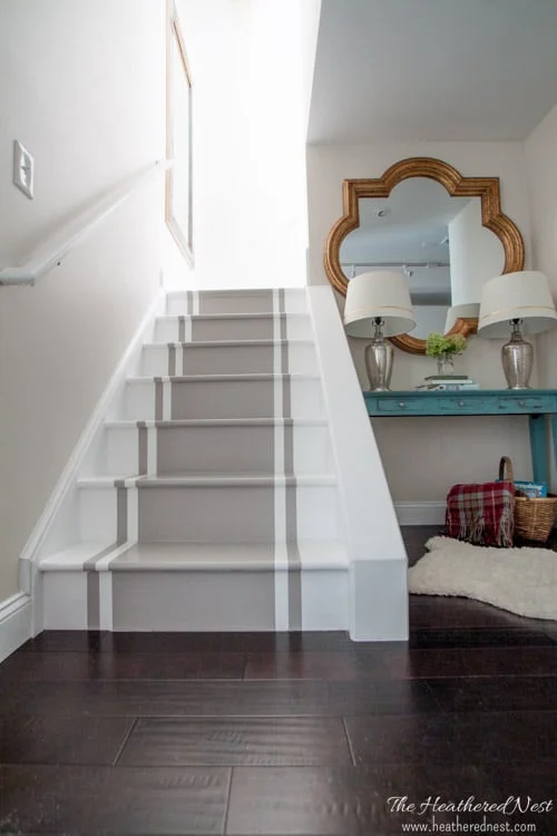 short basement stairs with painted runner and simple white handrail