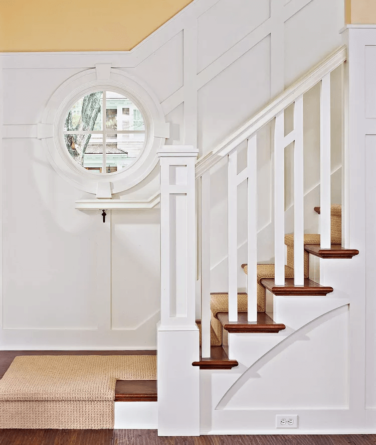 architectural stair railings with round window and board and batten in stairwell