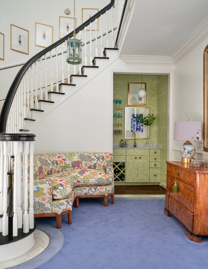 curved staircase with black stair railing