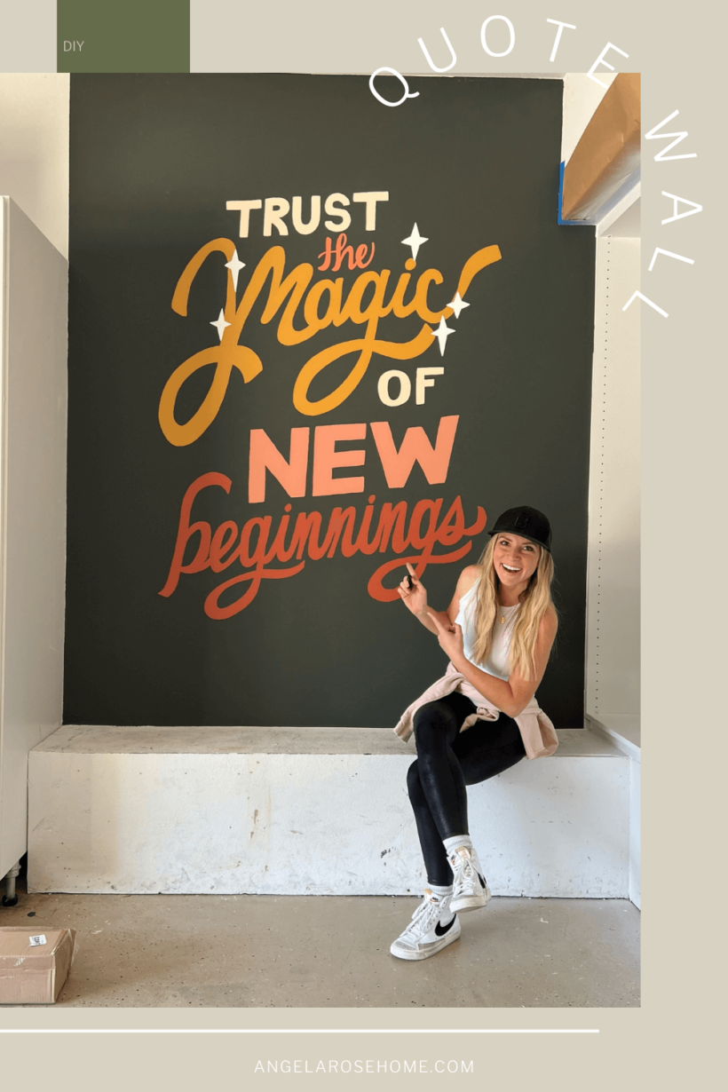 large hand painted wall quote in garage that says Trust the Magic of New Beginnings with woman sitting in front of it