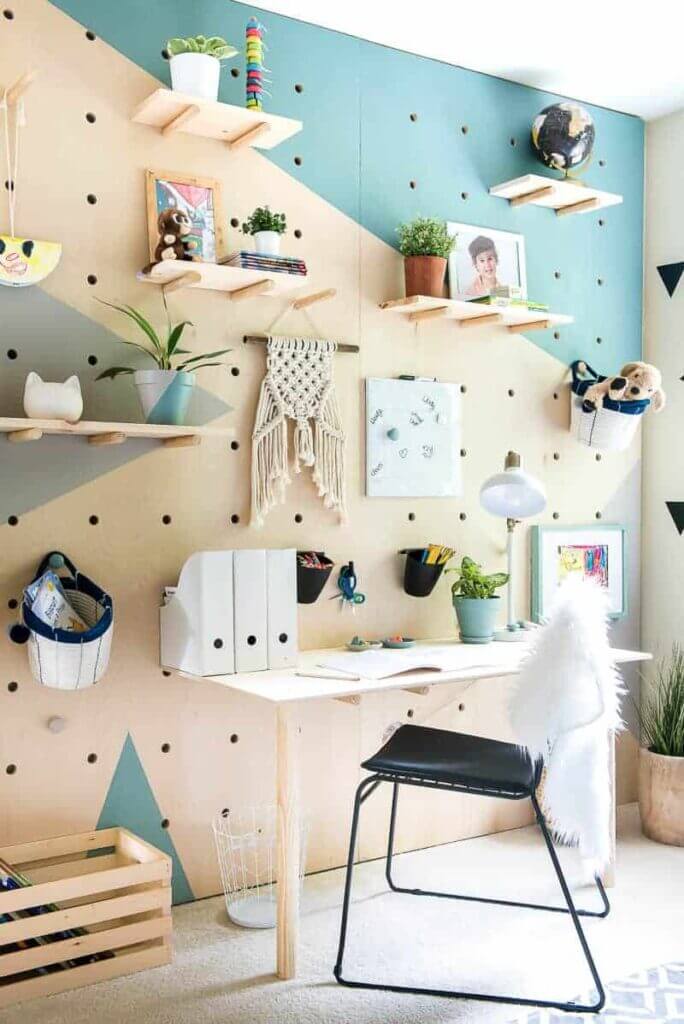 full wall giant wood pegboard with shelves, desk and hooks
