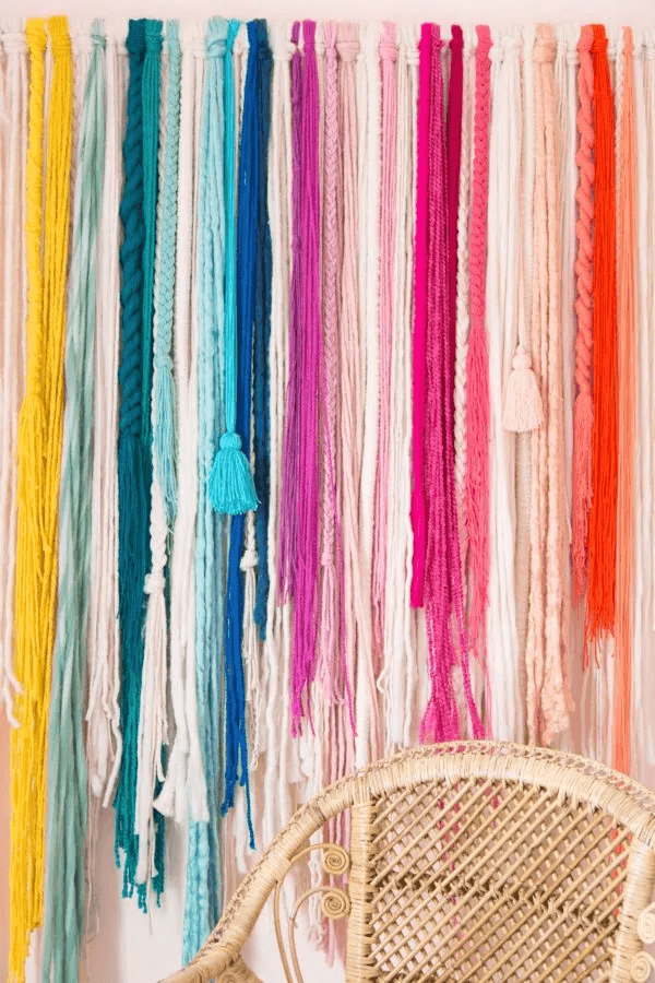 textured yarn wall hanging in rainbow colors