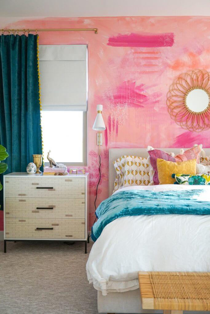colorful bedroom featuring pink DIY wall mural and dark teal curtains