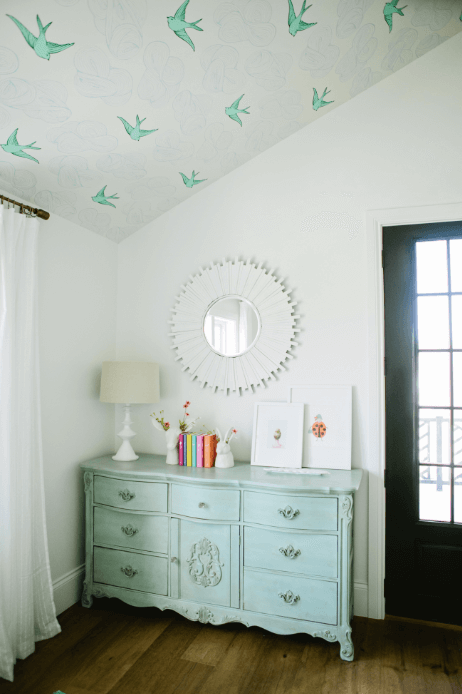 farmhouse girls' bedroom with bird wallpaper on ceiling