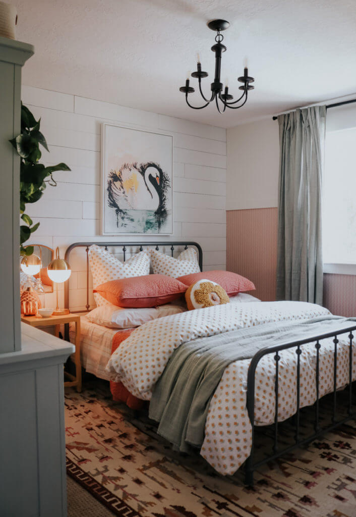 small neutral farmhouse girl's bedroom with blush bead board and swan painting over bed