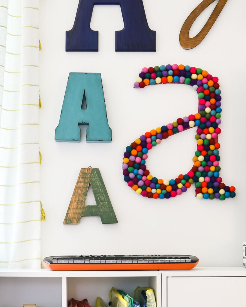 large DIY wall letter made with colorful felt balls