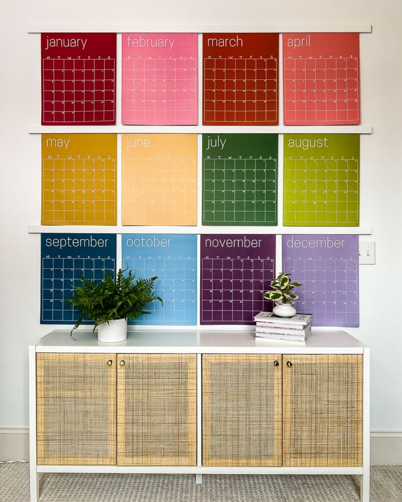 wall of giant rainbow wall calendars over cabinet 