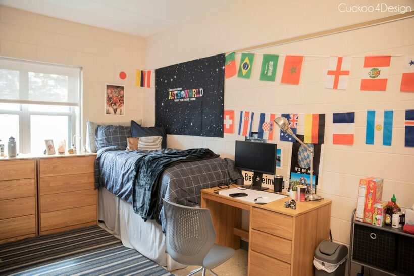 boys dorm room with international flags and gray bedding 