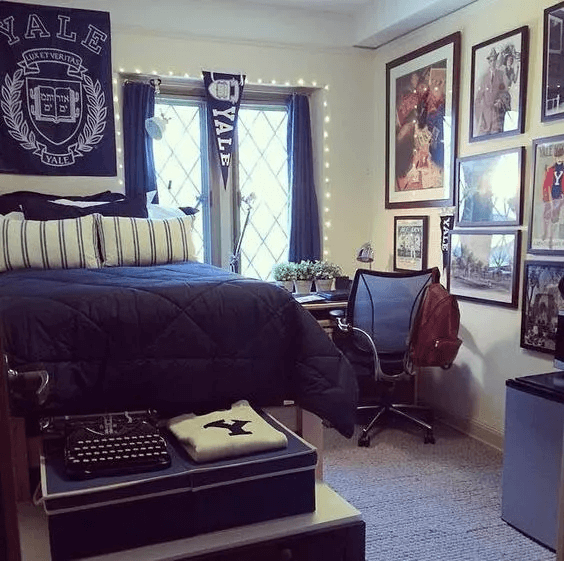 single dorm room at Yale with pennant, string lights, and antique typewriter