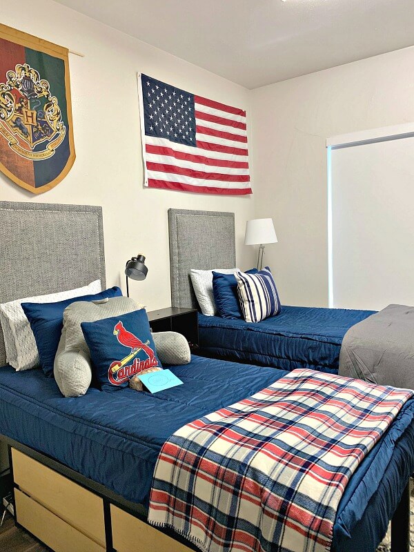 boy dorm room with gray headboards and blue bedding