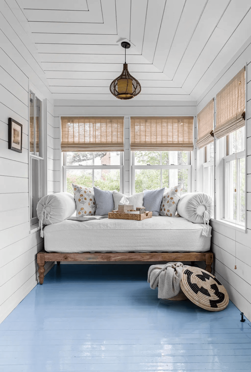 white sun porch with blue floor with daybed 