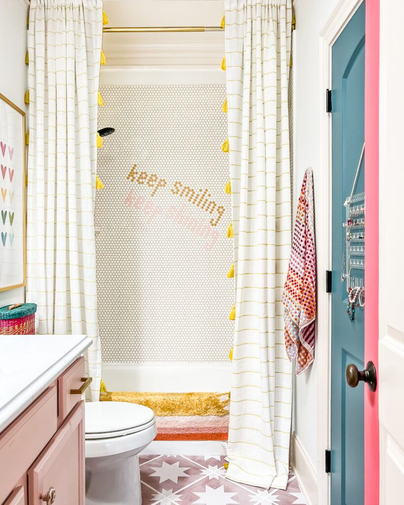 girl's bathroom with penny tile shower