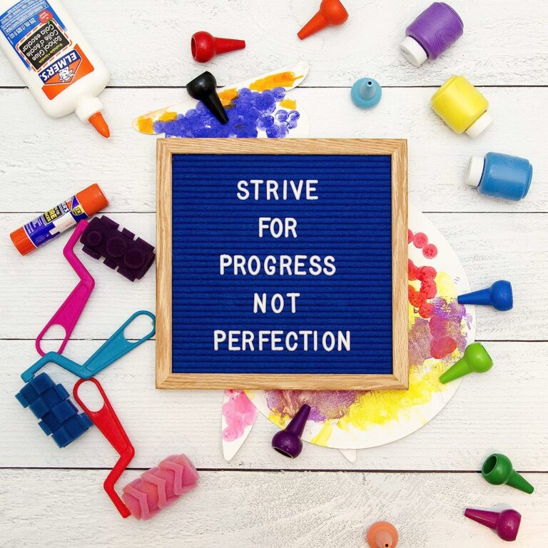 royal blue letter board with white letter in motivational message and craft supplies all around