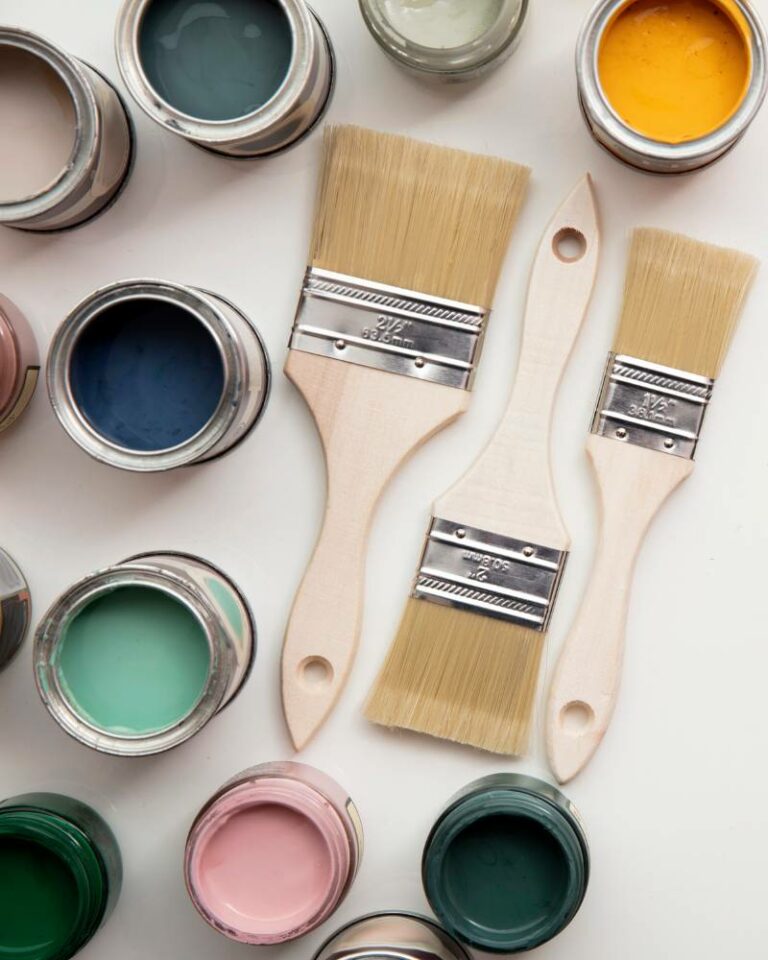 photo of open paint cans and paint brushes