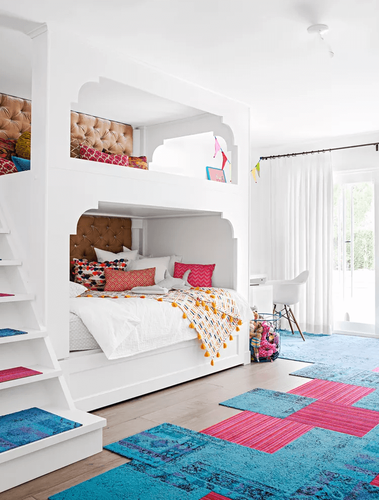 white built in bunk bed with bright decor and upholstered wall