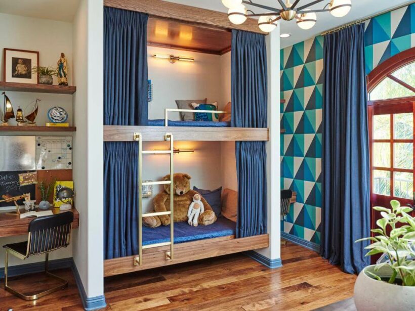 bunk beds with curtains and graphic blue and green wallpaper