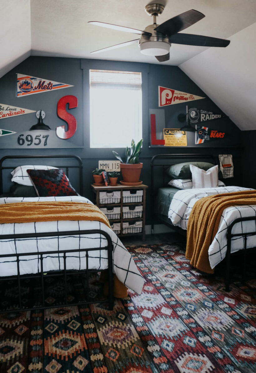 shared bedroom with twin beds pennant collection on wall