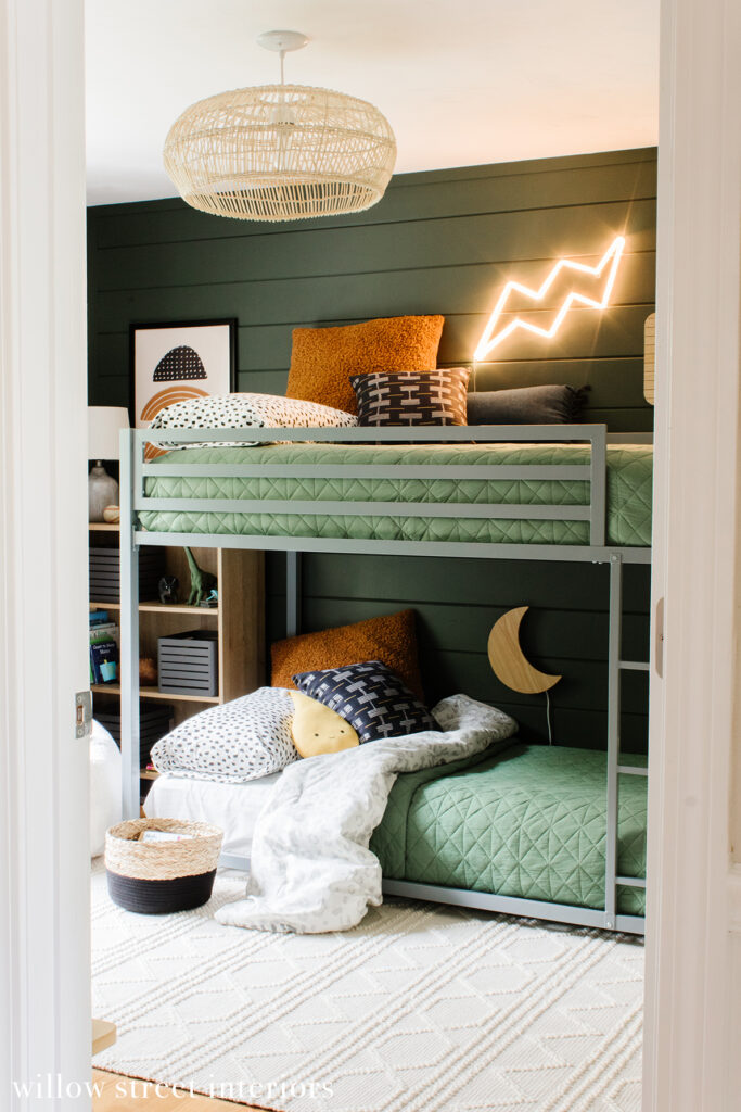 dark green walls and gray bunk bed with light green bedding