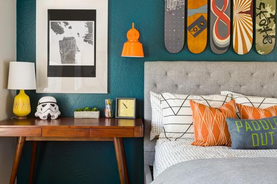 skateboards hanging above bed in teen boy's room