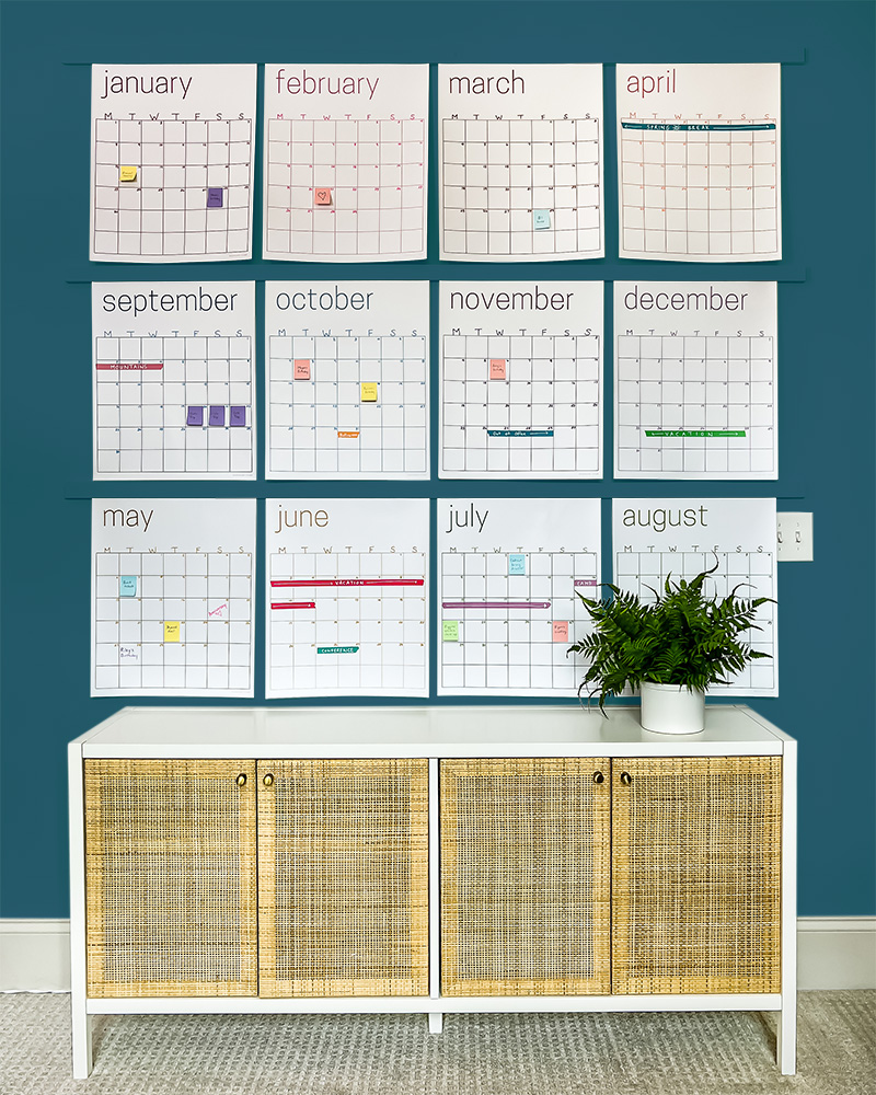 12 months of kaleidoscope living white wall calendar hanging above console table