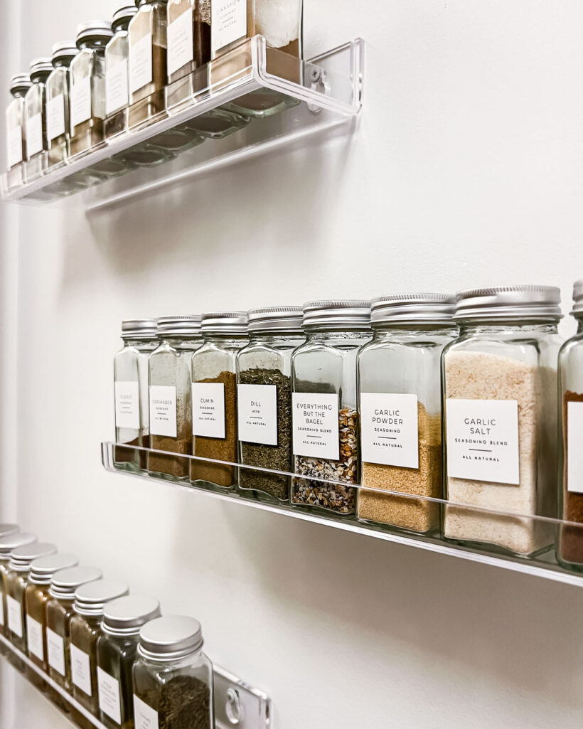 spices stored on clear acrylic wall shelves