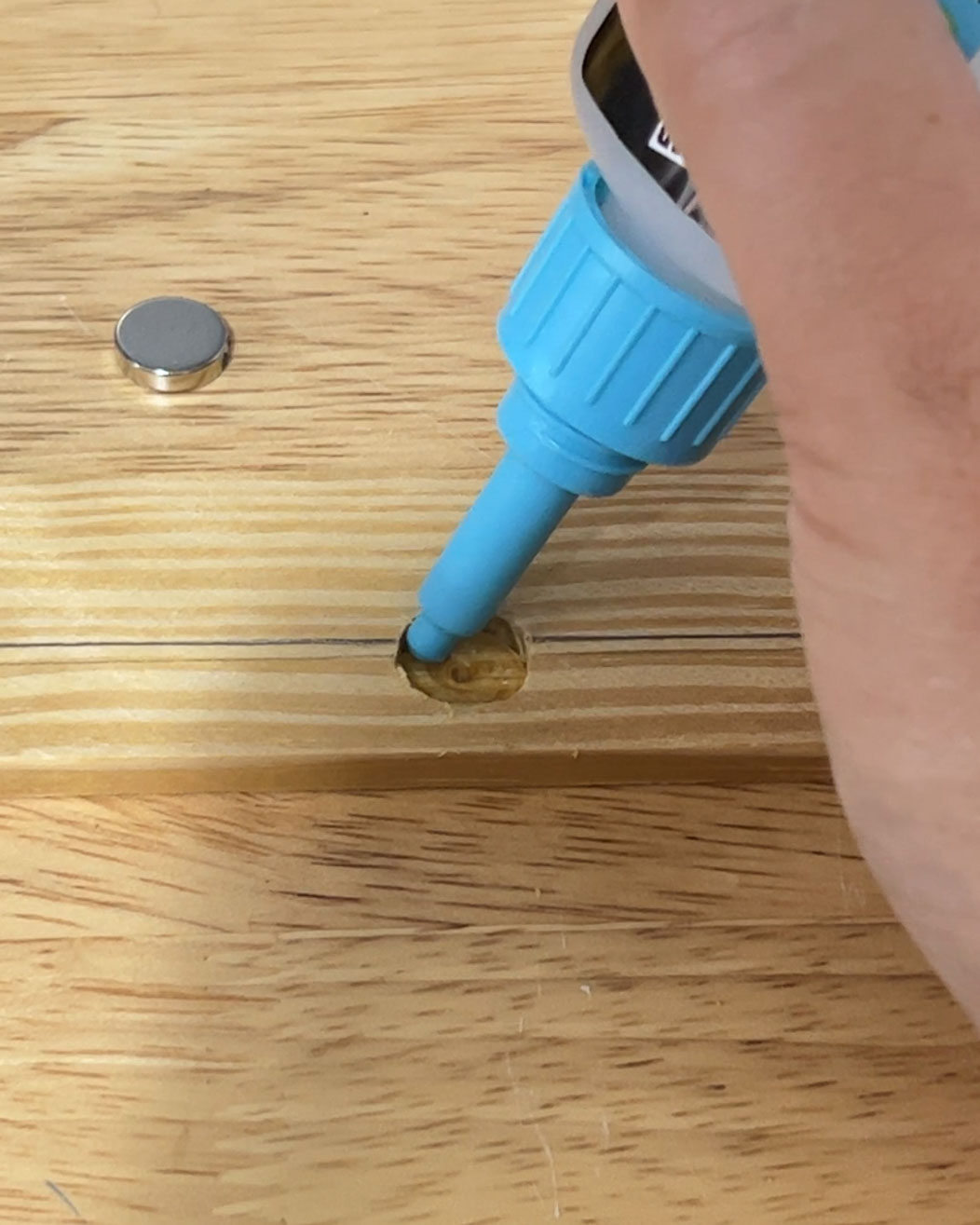 gluing small magnets into wood strip for magnetic poster hangers