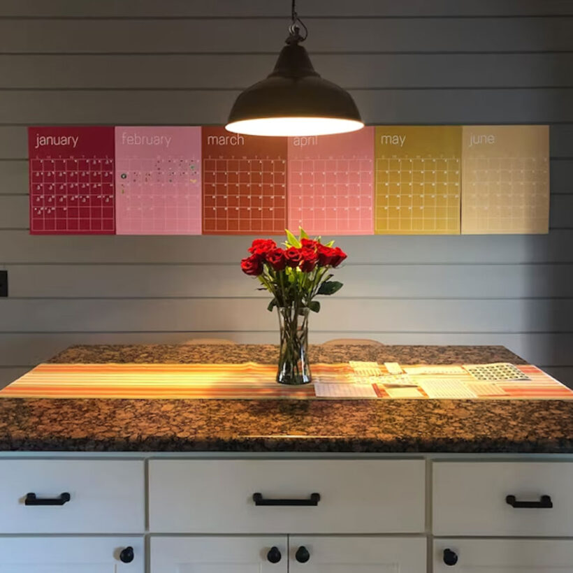 6 months of kaleidoscope living colorful wall calendar hanging in kitchen