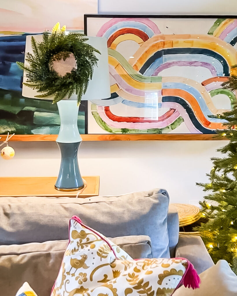 photo of mini wreath hanging on lampshade in colorful family room decorated for Christmas