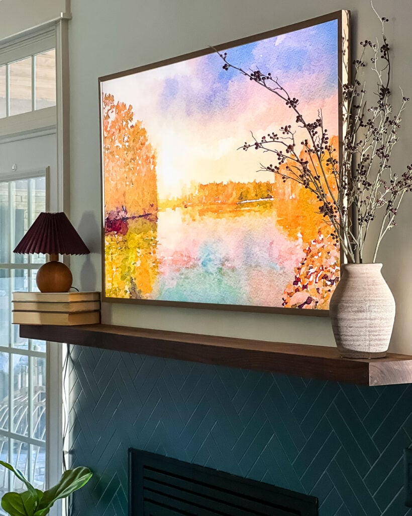 2021 Samsung frame TV model hanging above fireplace