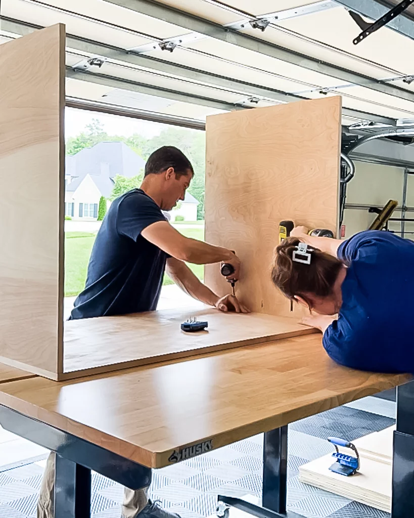 man and woman assembling DIY dog crate made from plywood